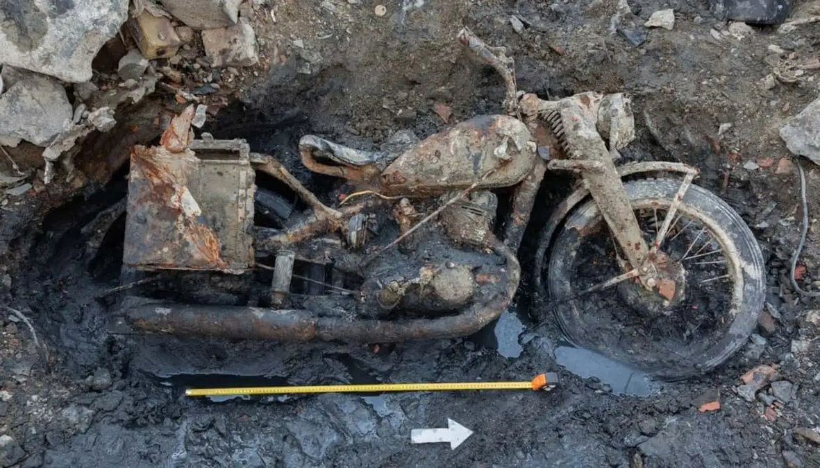 Una motocicletta tedesca della Seconda Guerra Mondiale emerge dal fango del Danubio, accompagnata da reperti militari